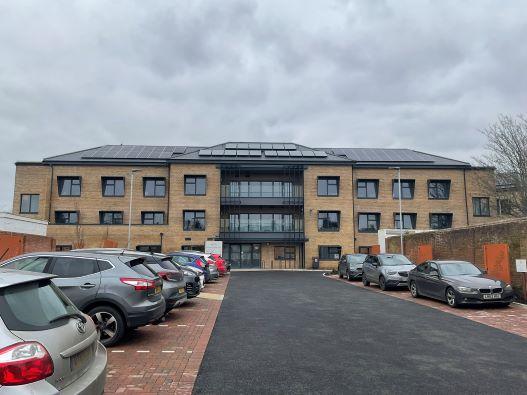 View of the front of Marigold House building with cars in the car park