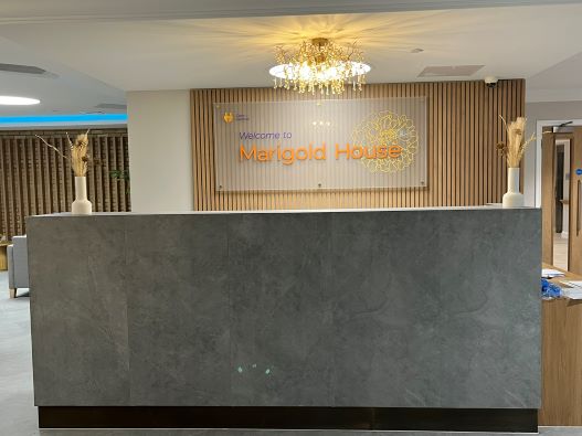 Reception desk with sign above reading Marigold House